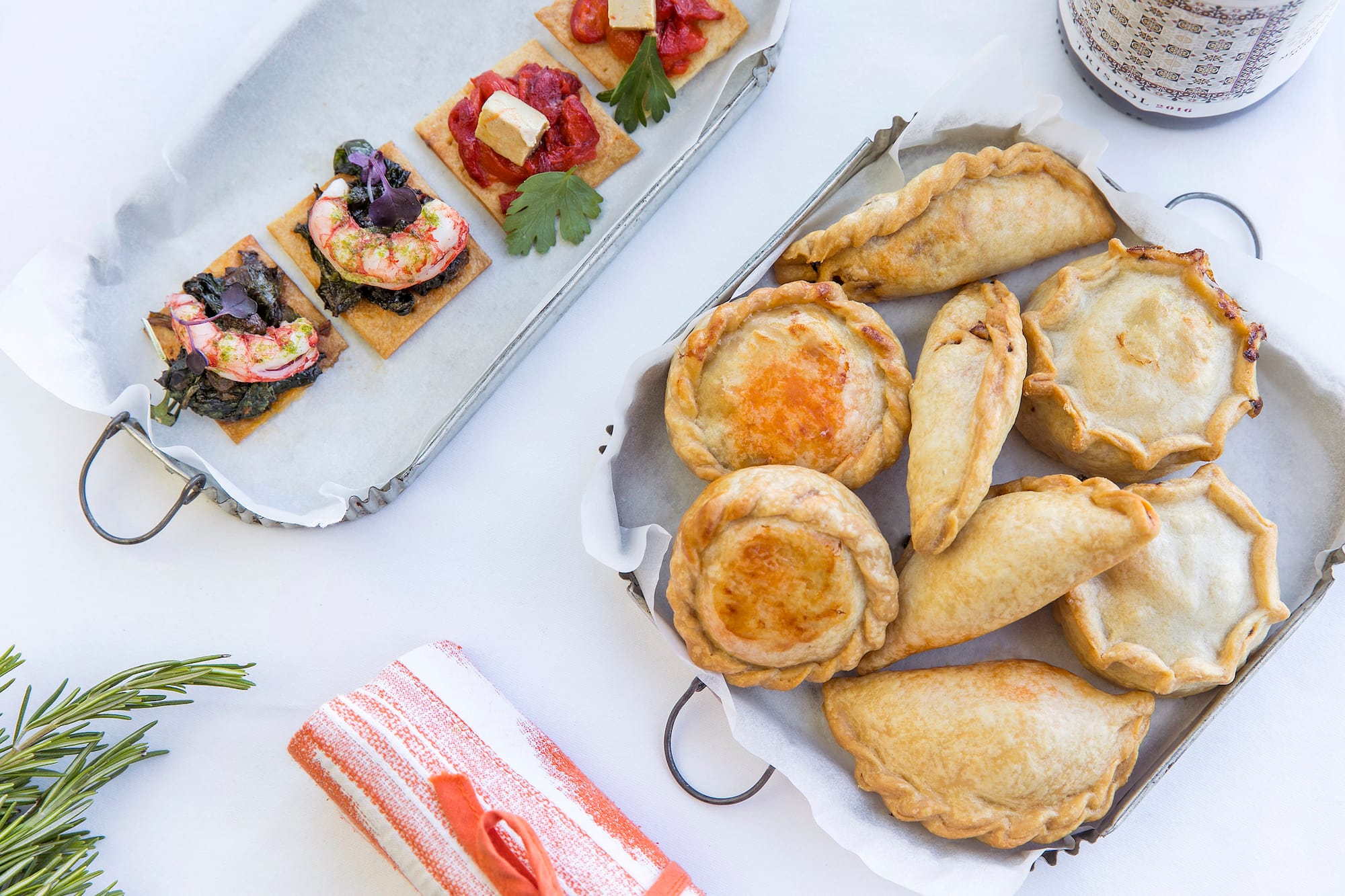 a tray of pastries and a plate of food