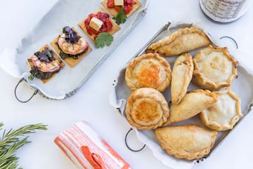 a tray of pastries and a plate of food