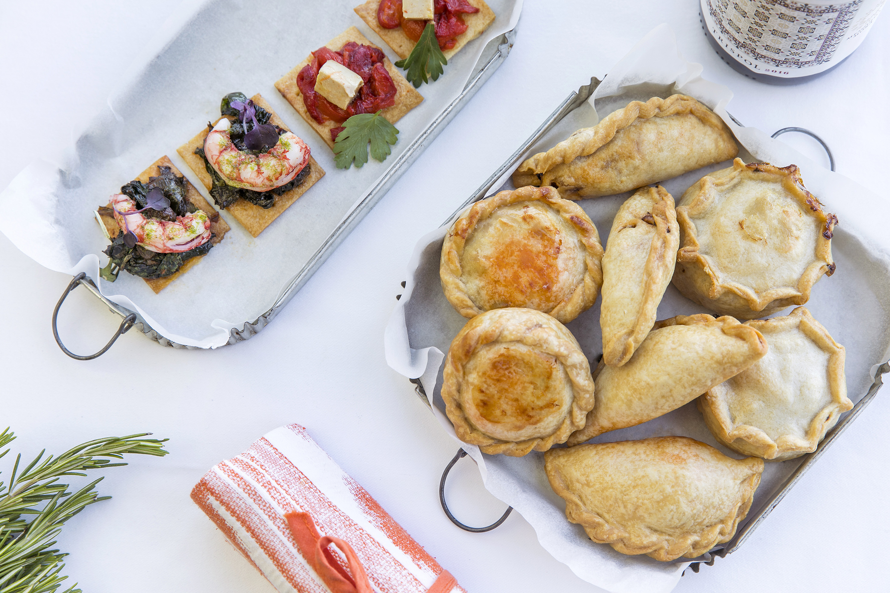 a tray of pastries and a plate of food