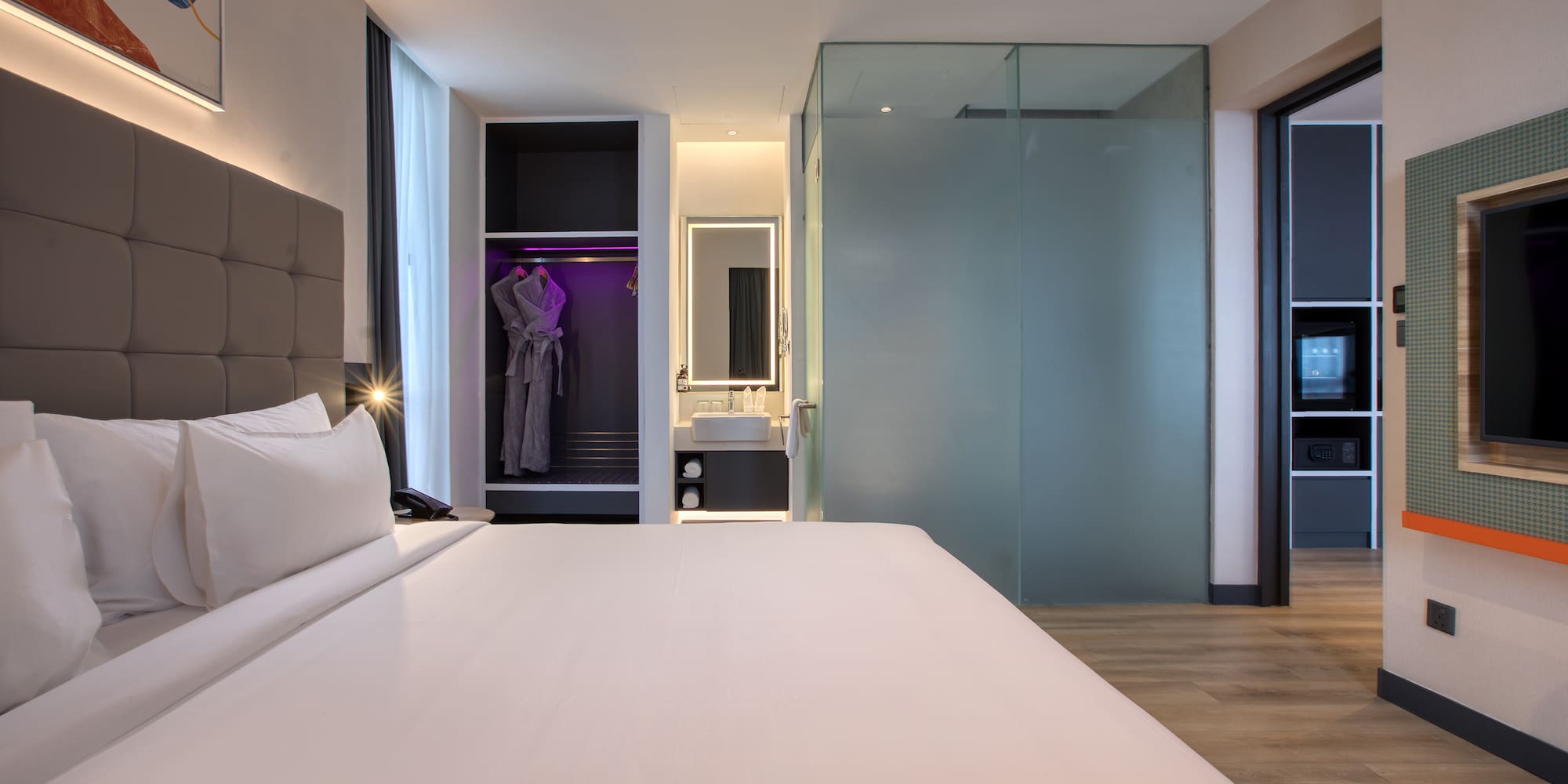 a room with a bed and a mirror