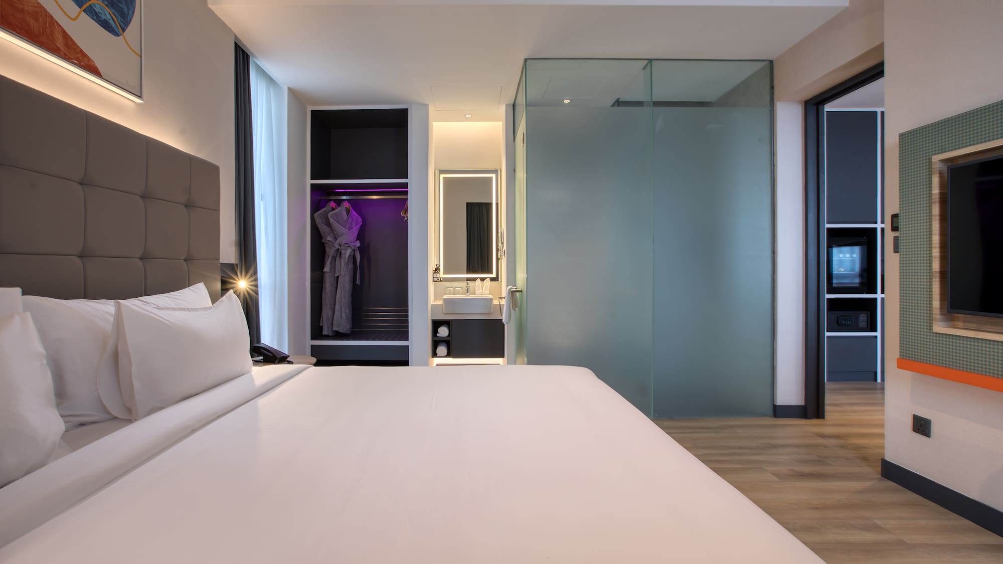 a room with a bed and a mirror