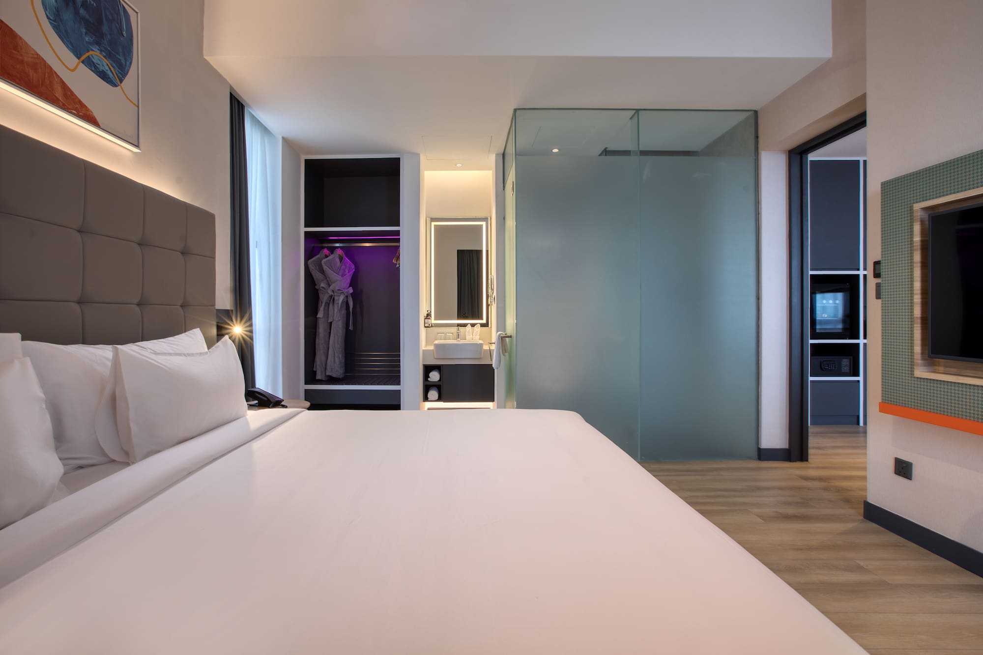 a room with a bed and a mirror