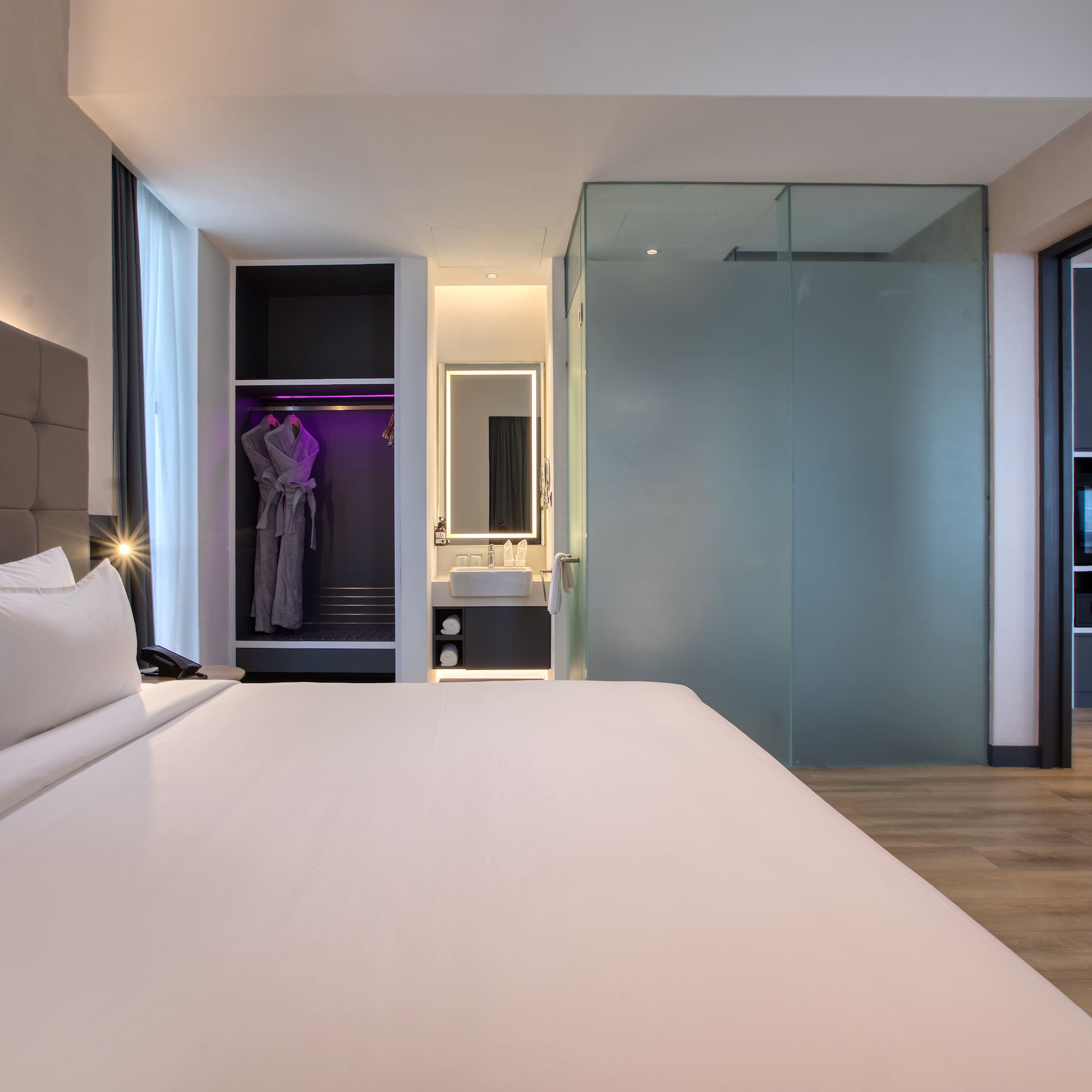 a room with a bed and a mirror