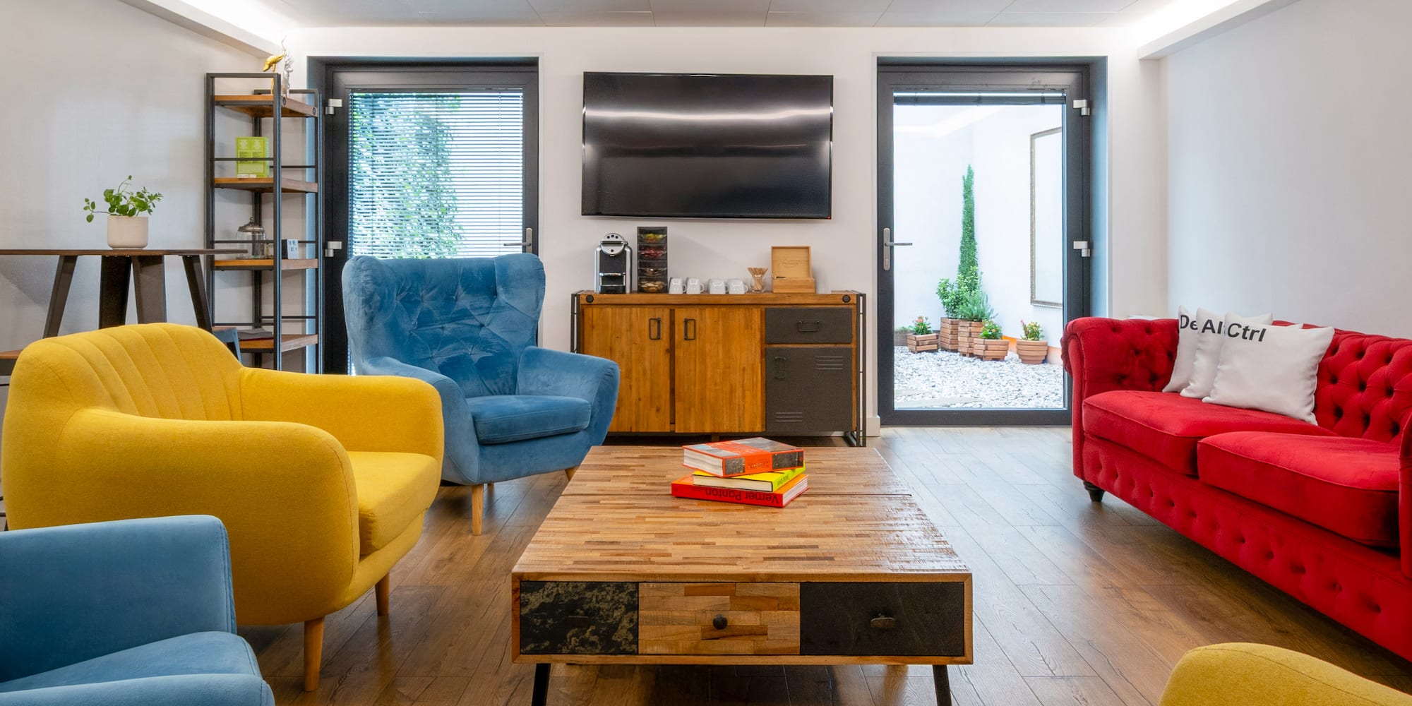 a room with a coffee table and chairs