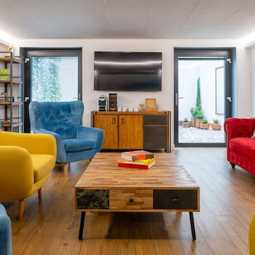 a room with a coffee table and chairs