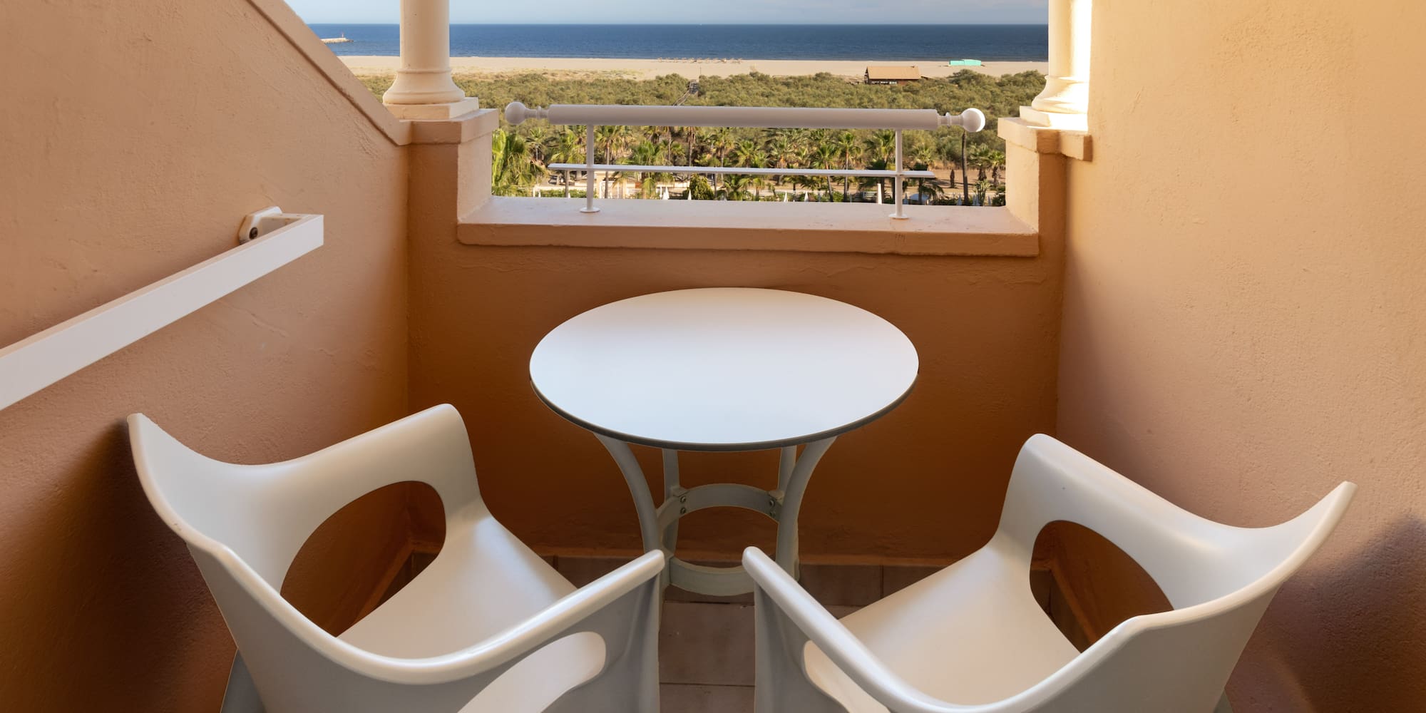 a table and chairs on a balcony