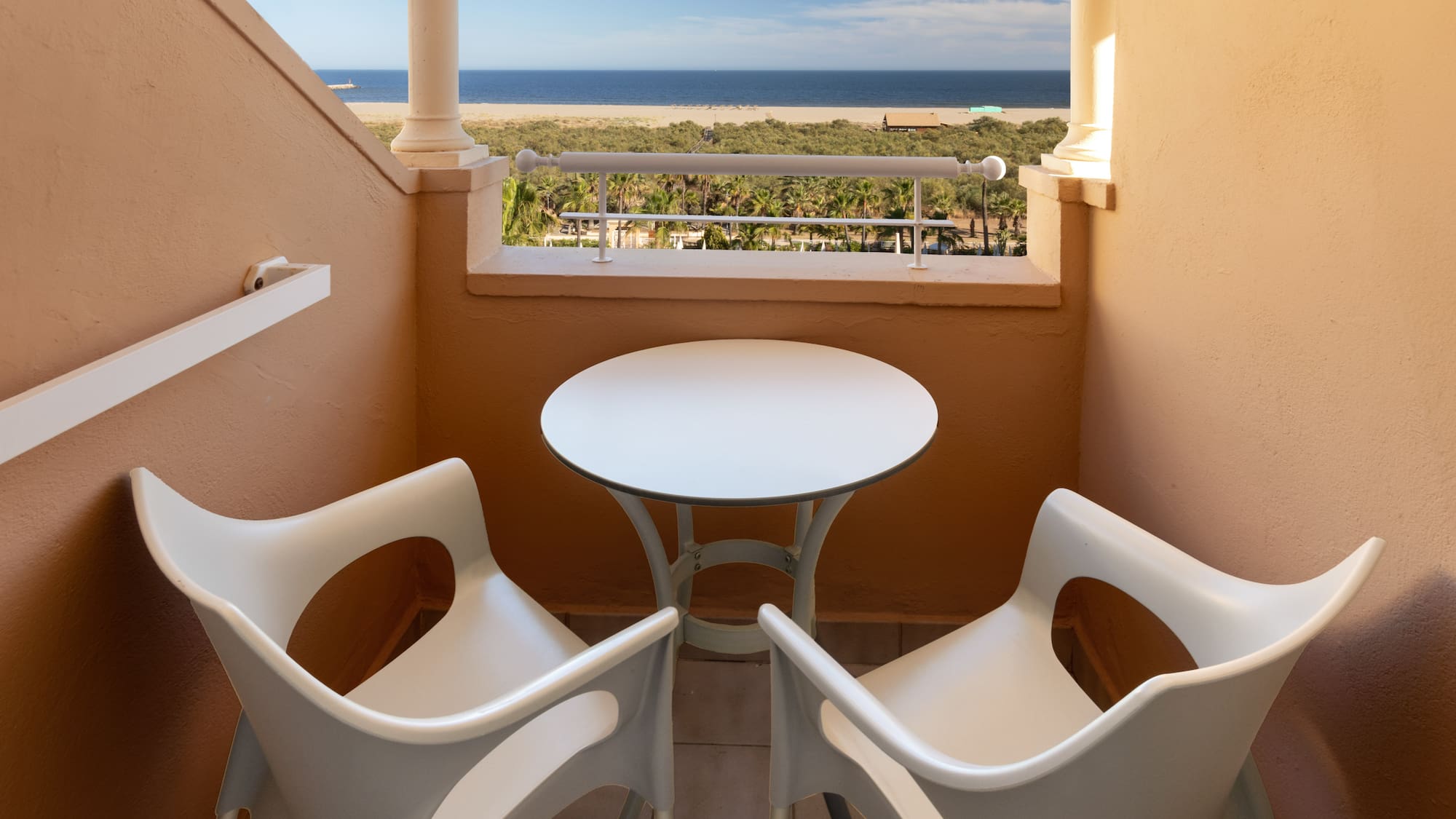 a table and chairs on a balcony