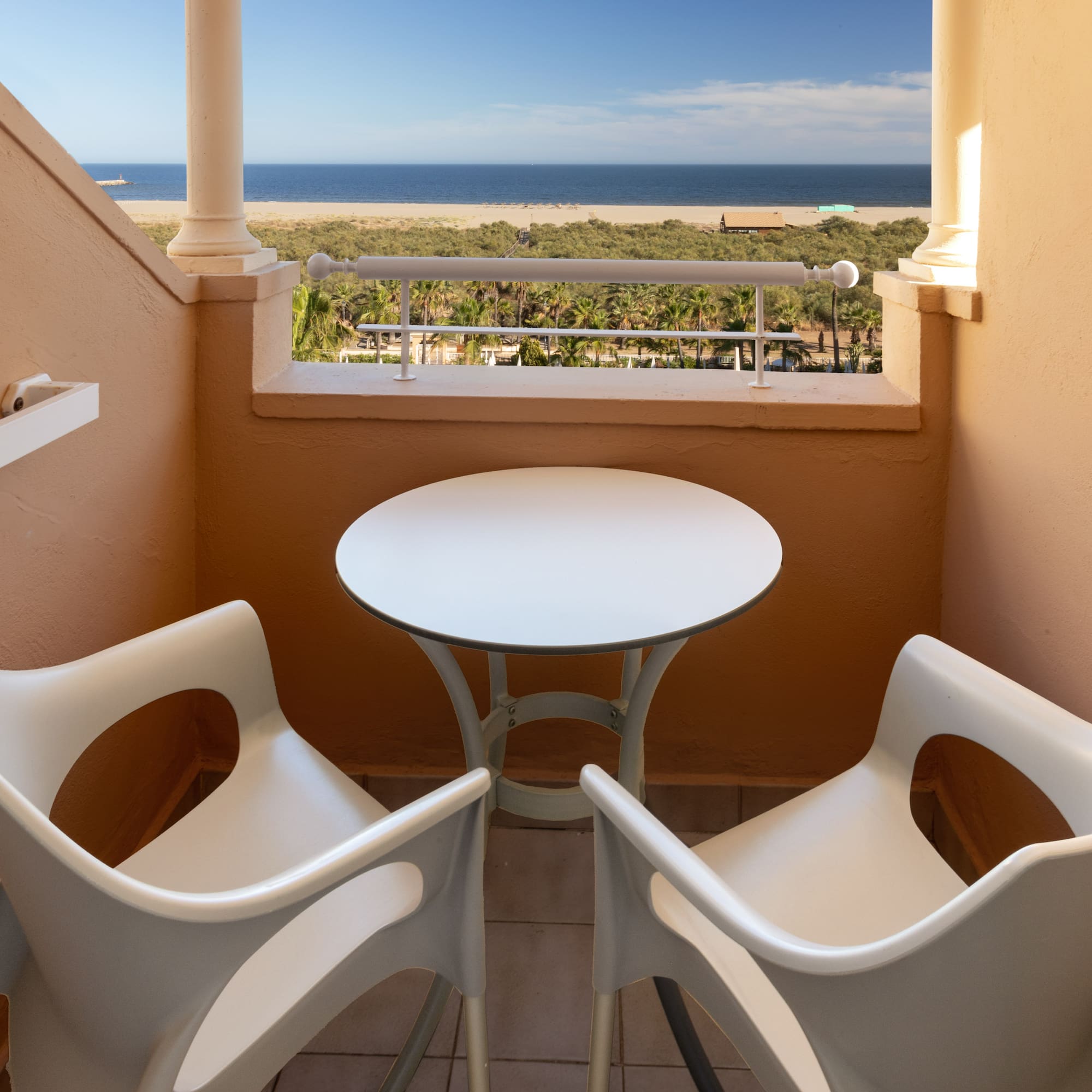 a table and chairs on a balcony