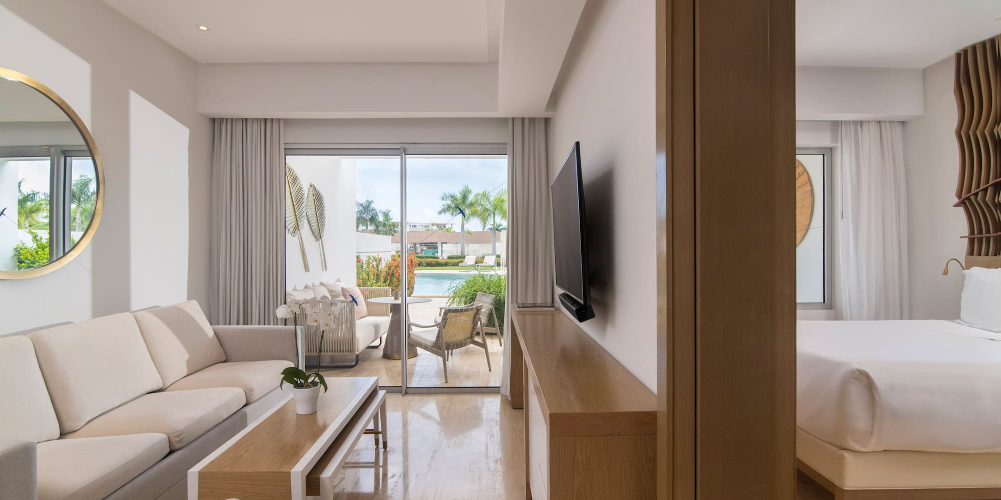 a living room with a television and a bed