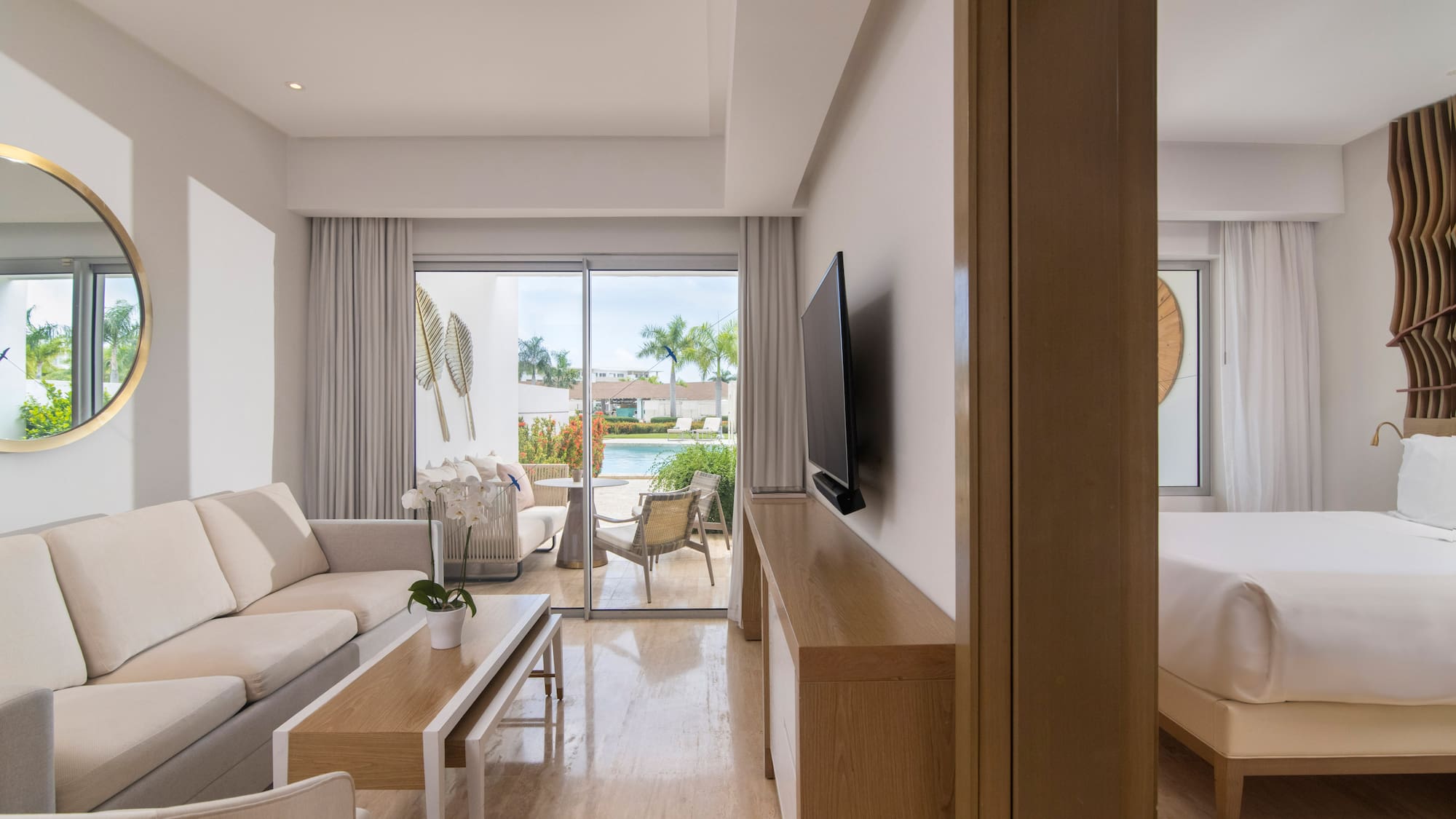 a living room with a television and a bed