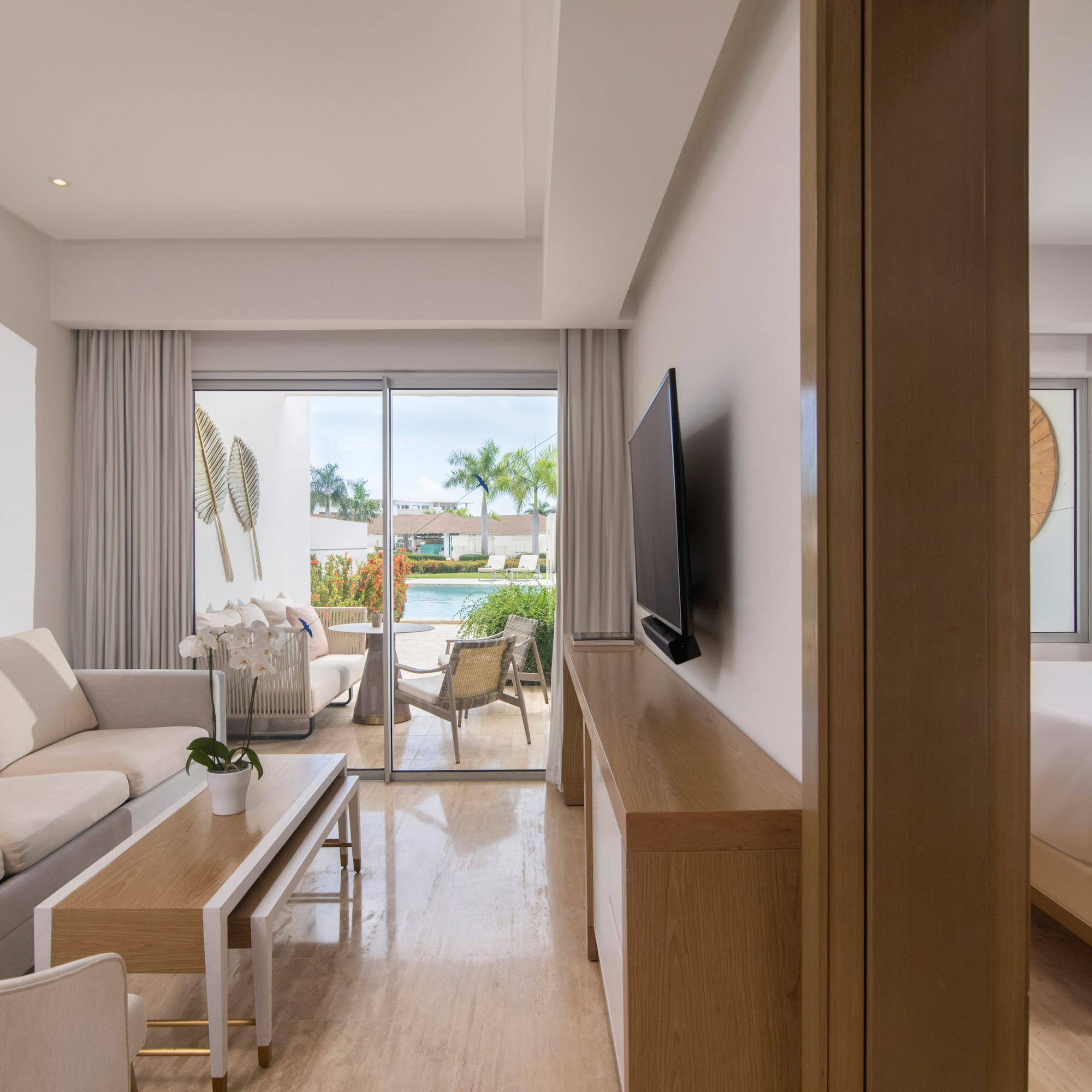 a living room with a television and a bed