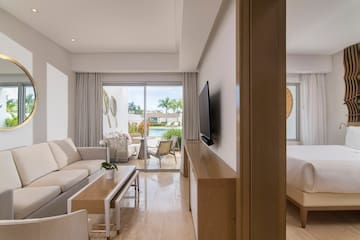 a living room with a television and a bed
