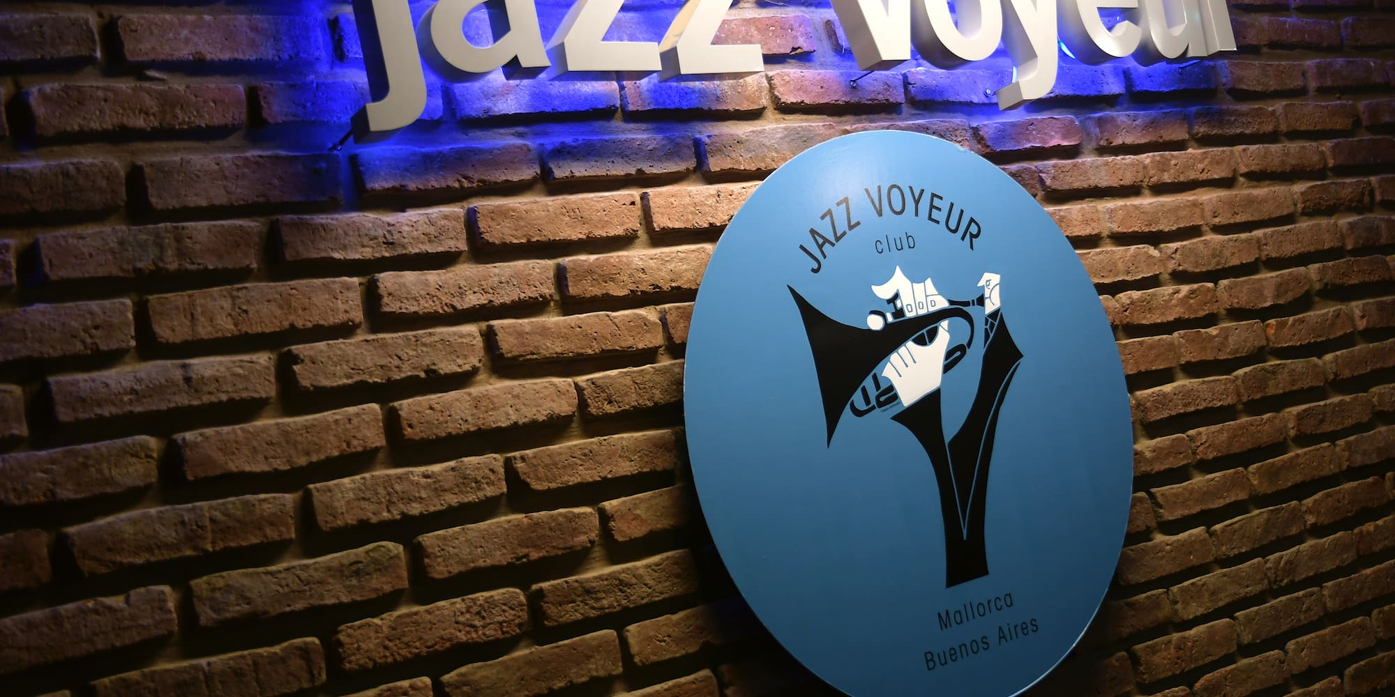 a sign on a brick wall