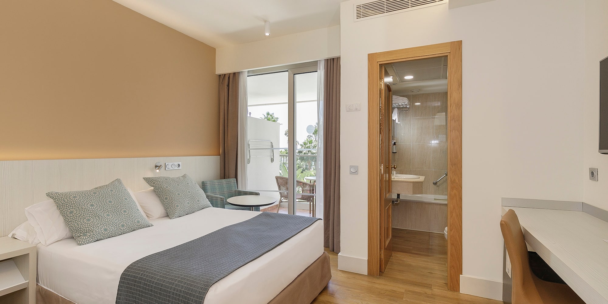 a bedroom with a bed and a glass door