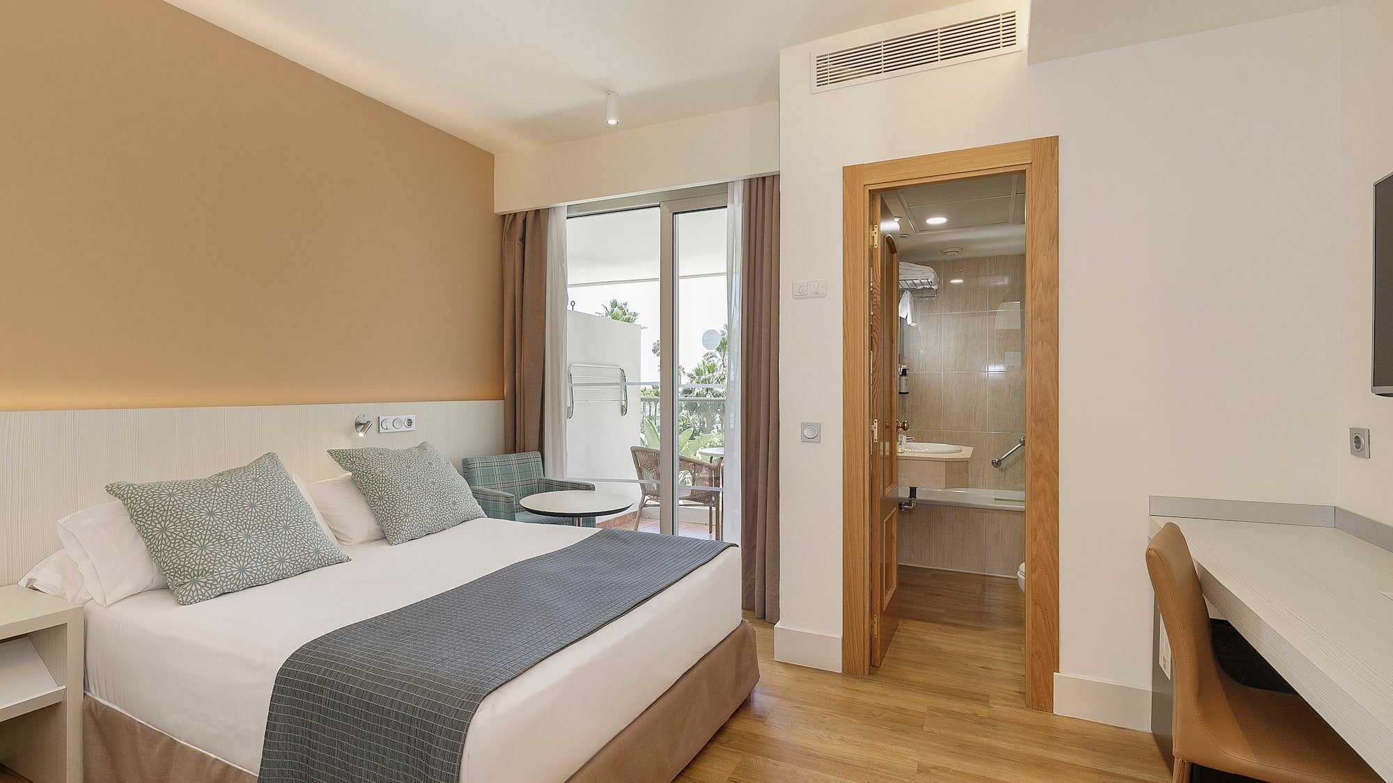 a bedroom with a bed and a glass door