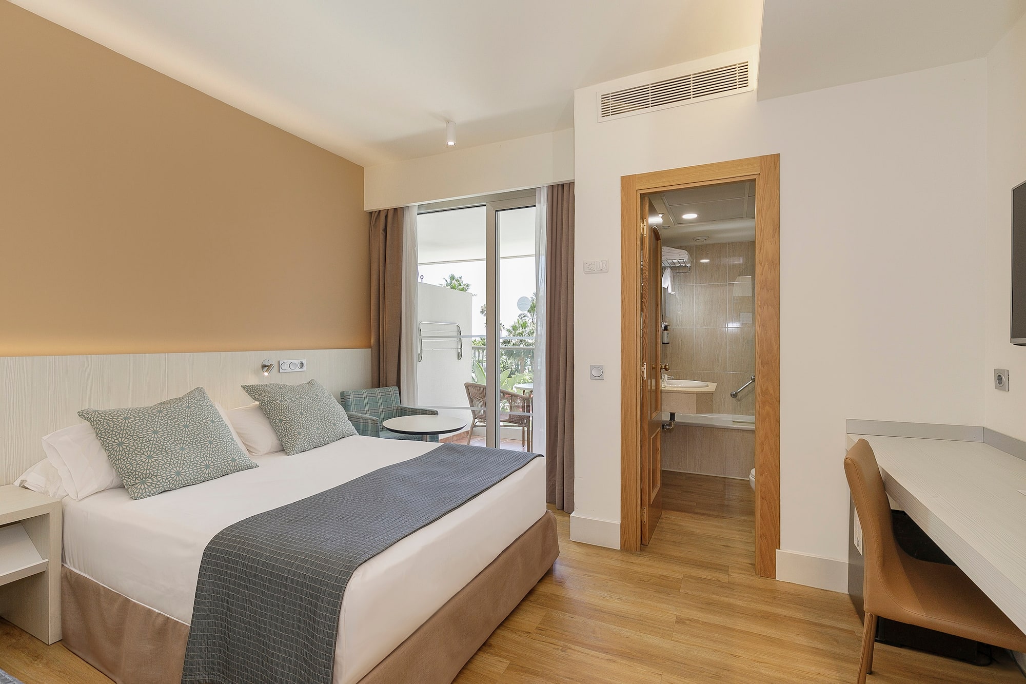 a bedroom with a bed and a glass door