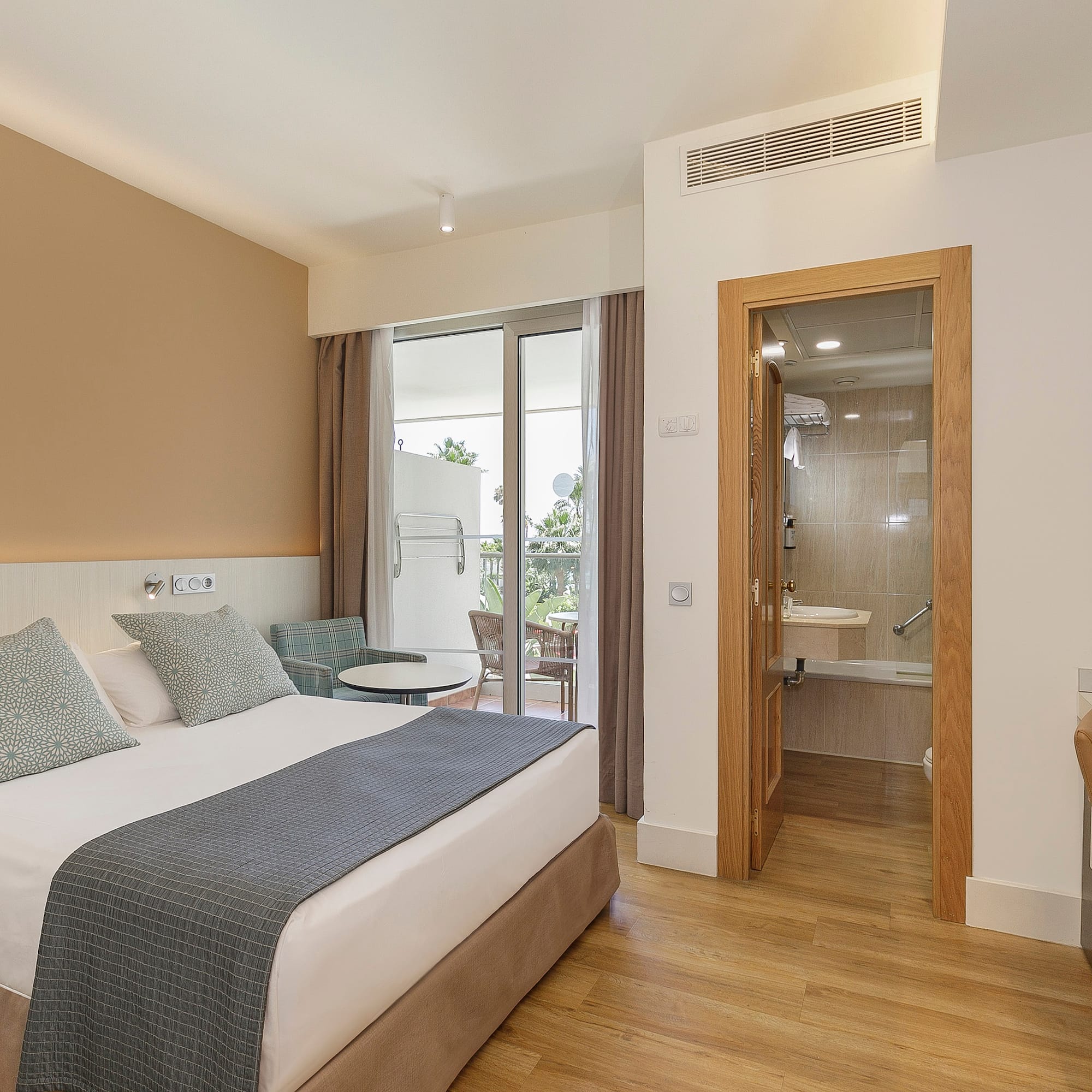 a bedroom with a bed and a glass door