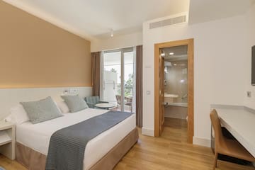 a bedroom with a bed and a glass door