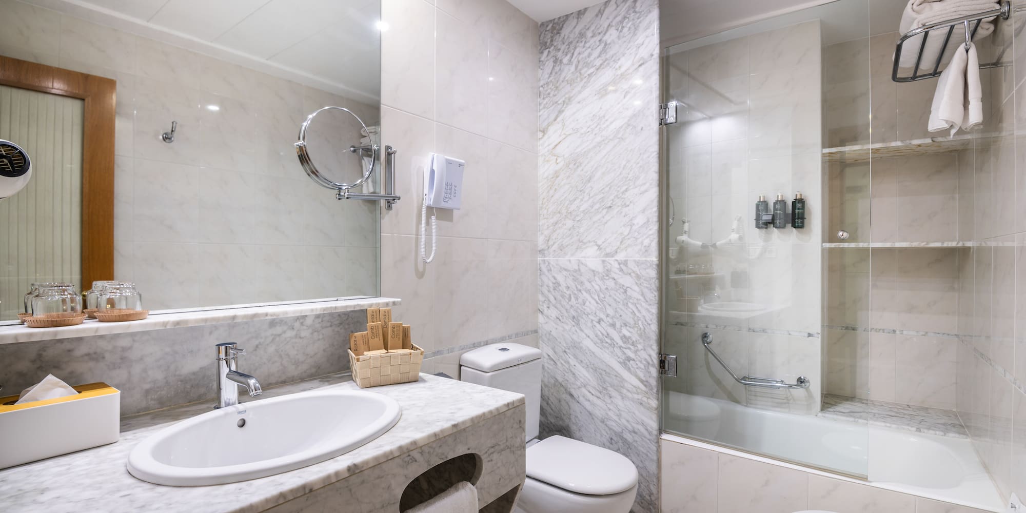 a bathroom with marble walls and a shower