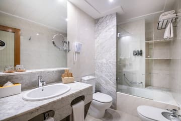 a bathroom with marble walls and a shower