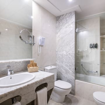 a bathroom with marble walls and a shower