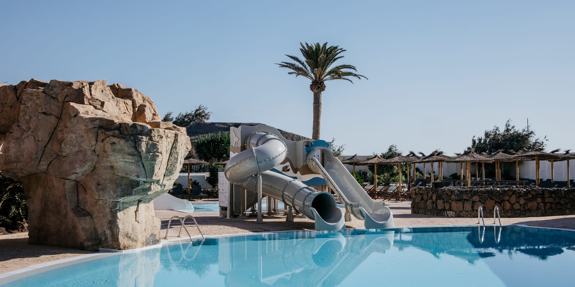 a water slide next to a pool