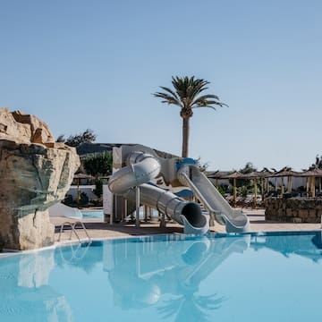 a water slide next to a pool
