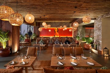 a room with tables and chairs and lamps