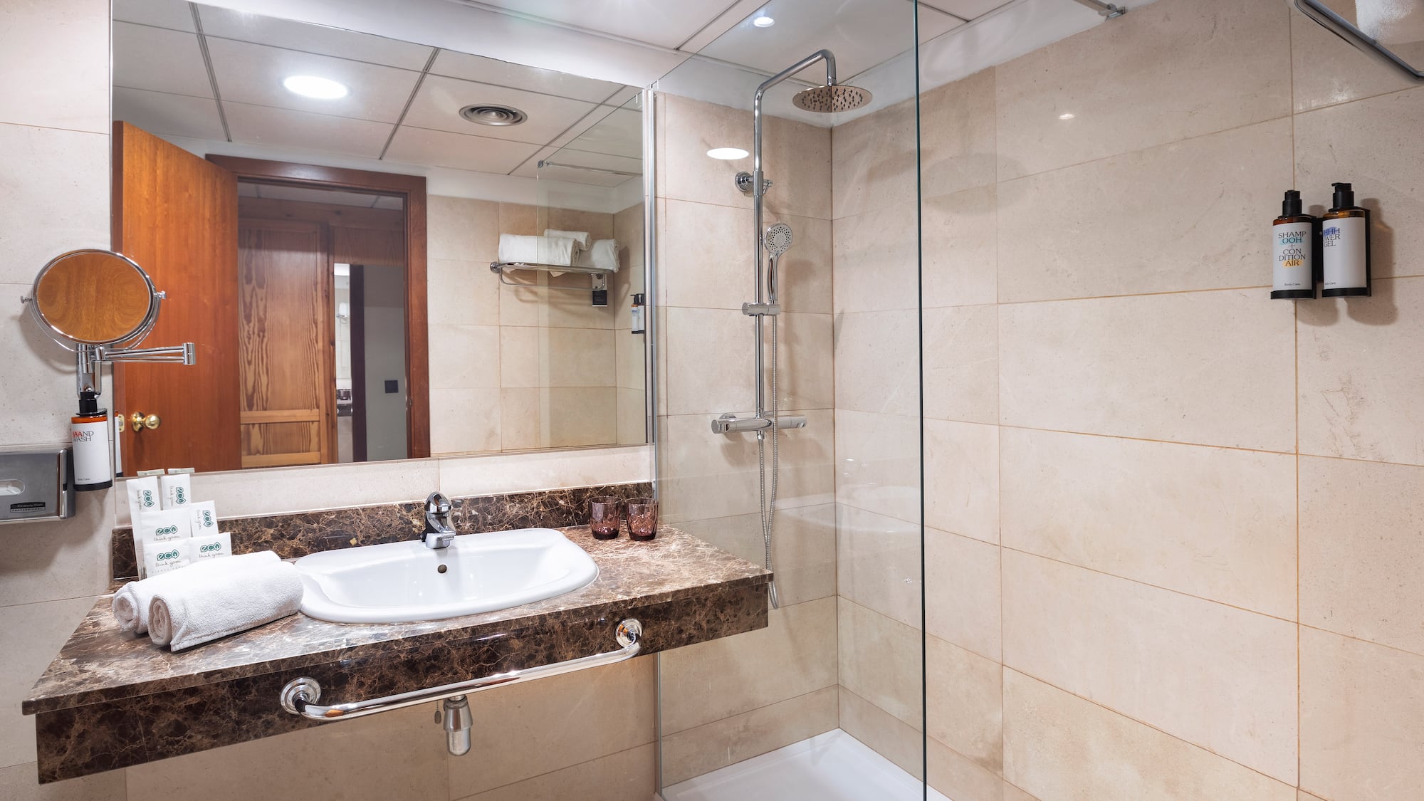 a bathroom with a glass shower and sink