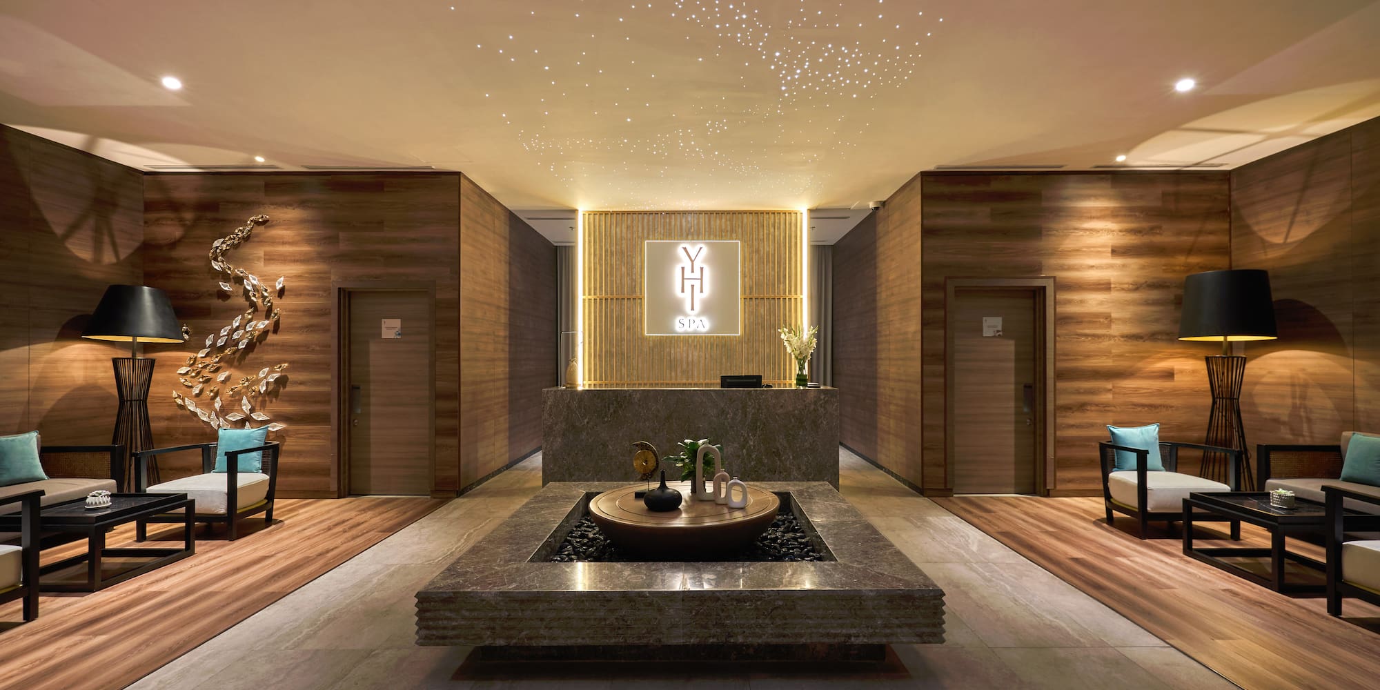 a room with a fountain and chairs