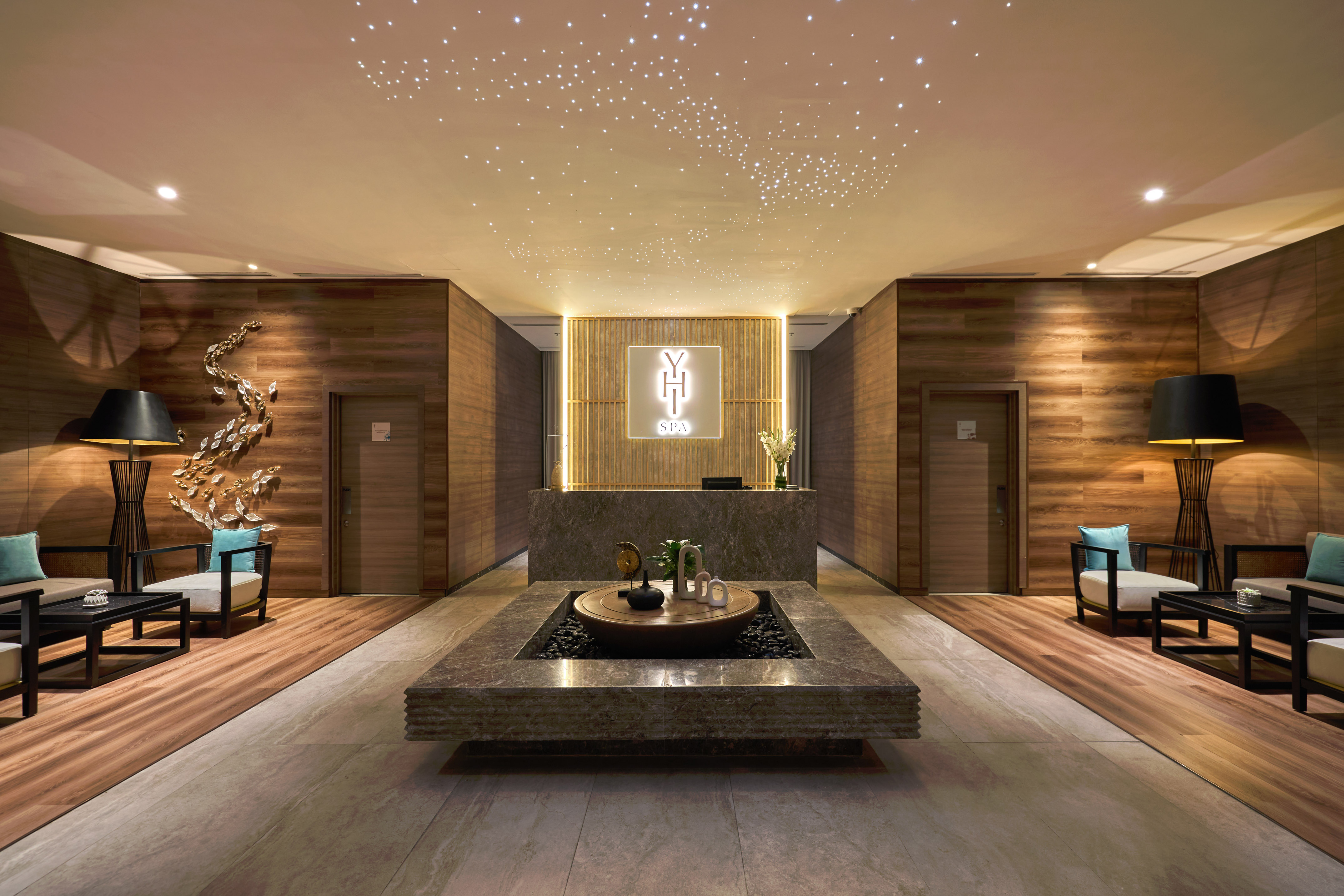 a room with a fountain and chairs