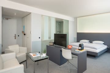 a room with a tv and a bed