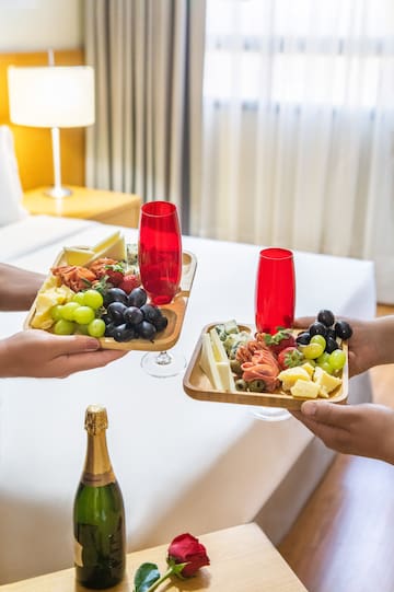 a pair of hands holding plates of food