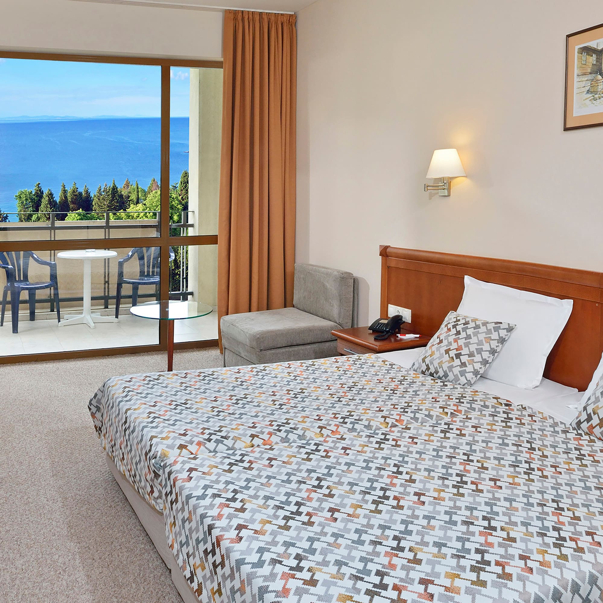 a bedroom with a large window overlooking the ocean