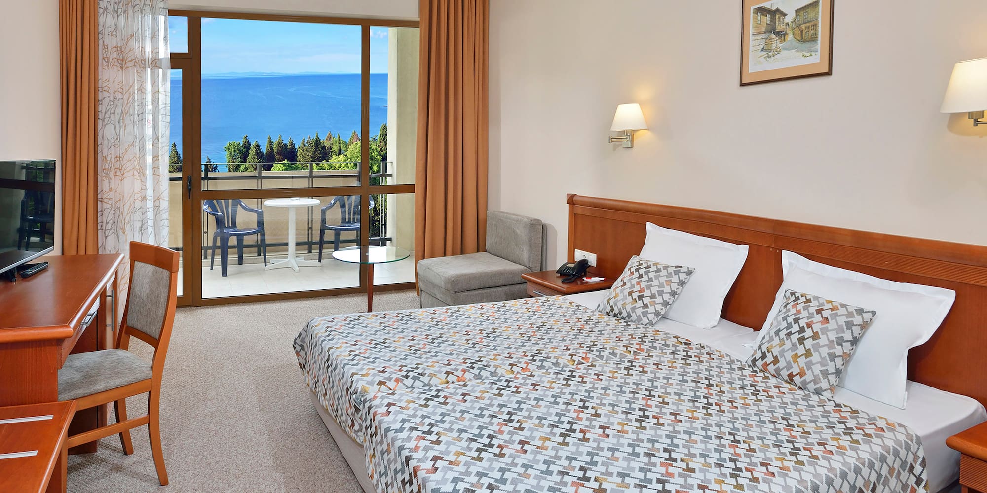 a bedroom with a large window overlooking the ocean
