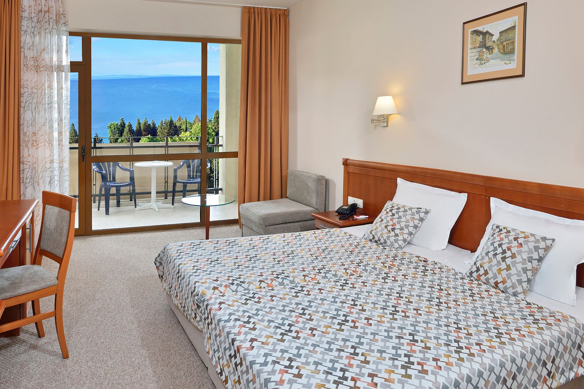 a bedroom with a large window overlooking the ocean