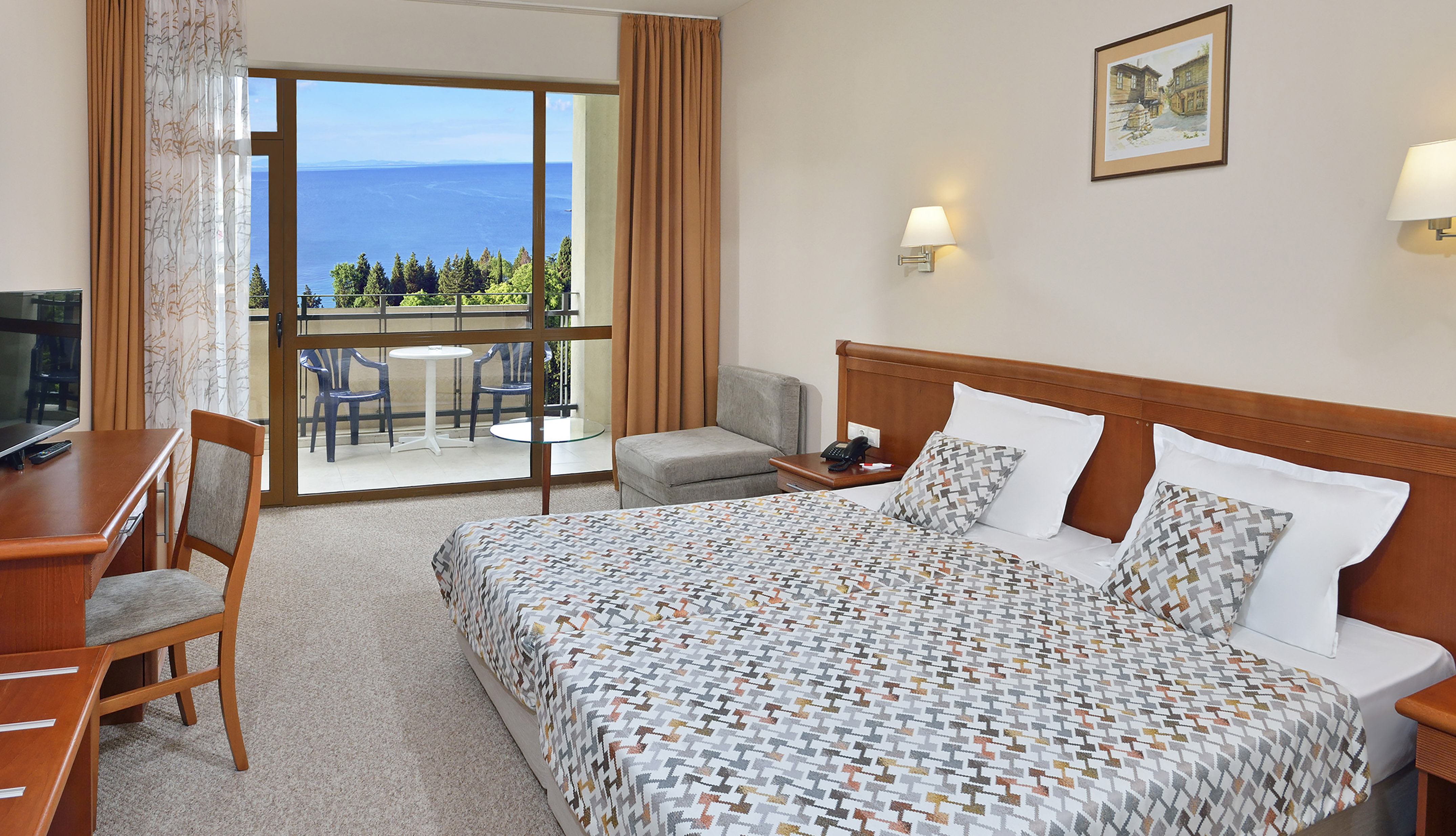 a bedroom with a large window overlooking the ocean
