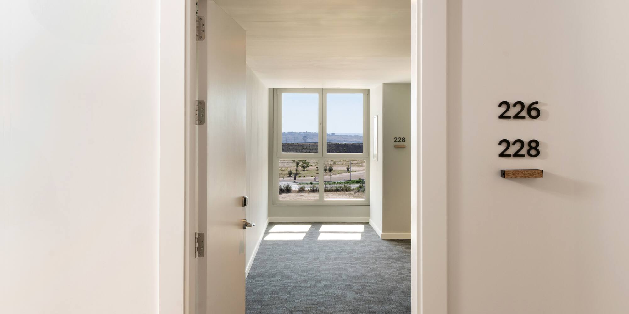 a hallway with a door and a window