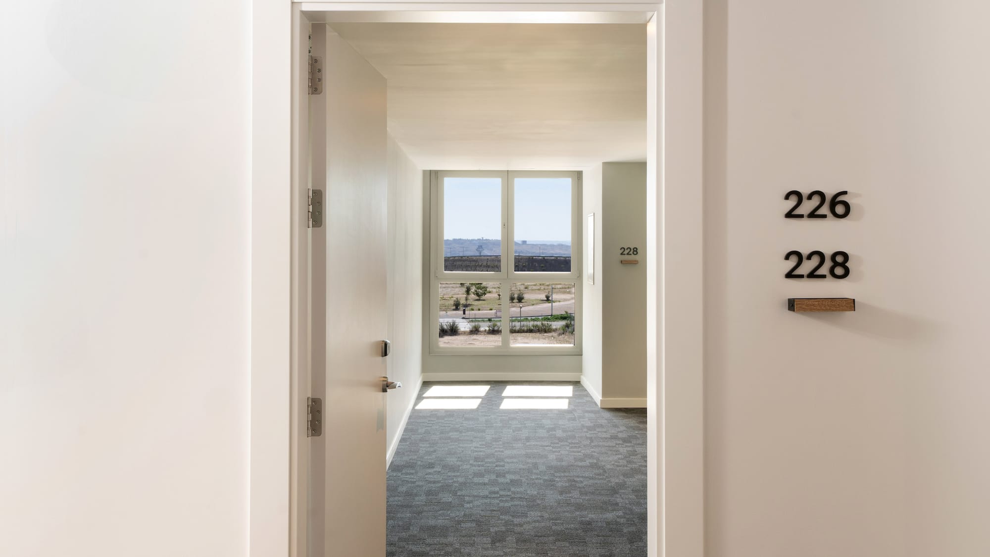 a hallway with a door and a window