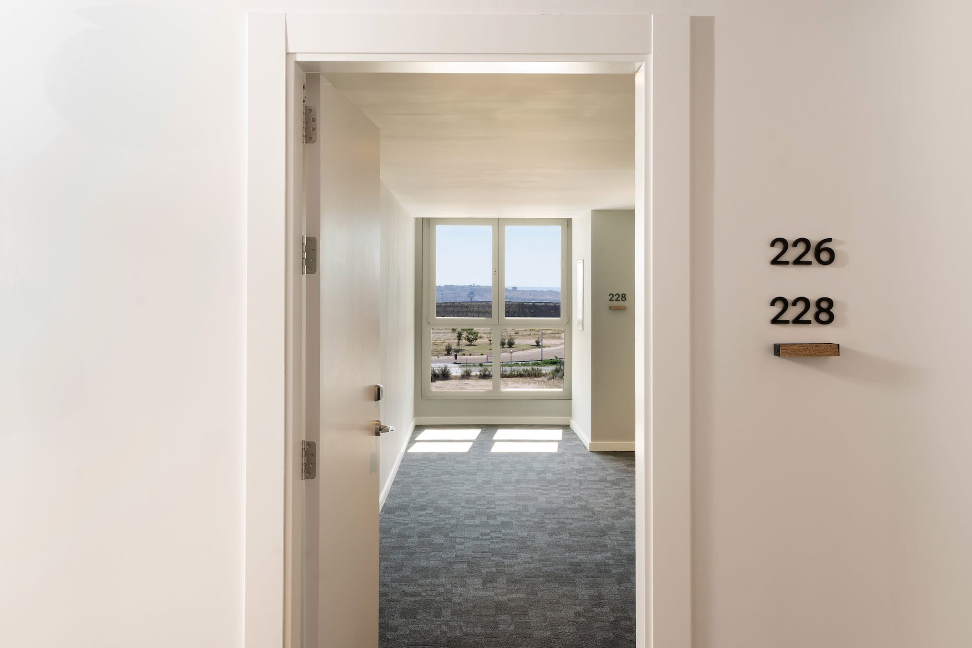 a hallway with a door and a window