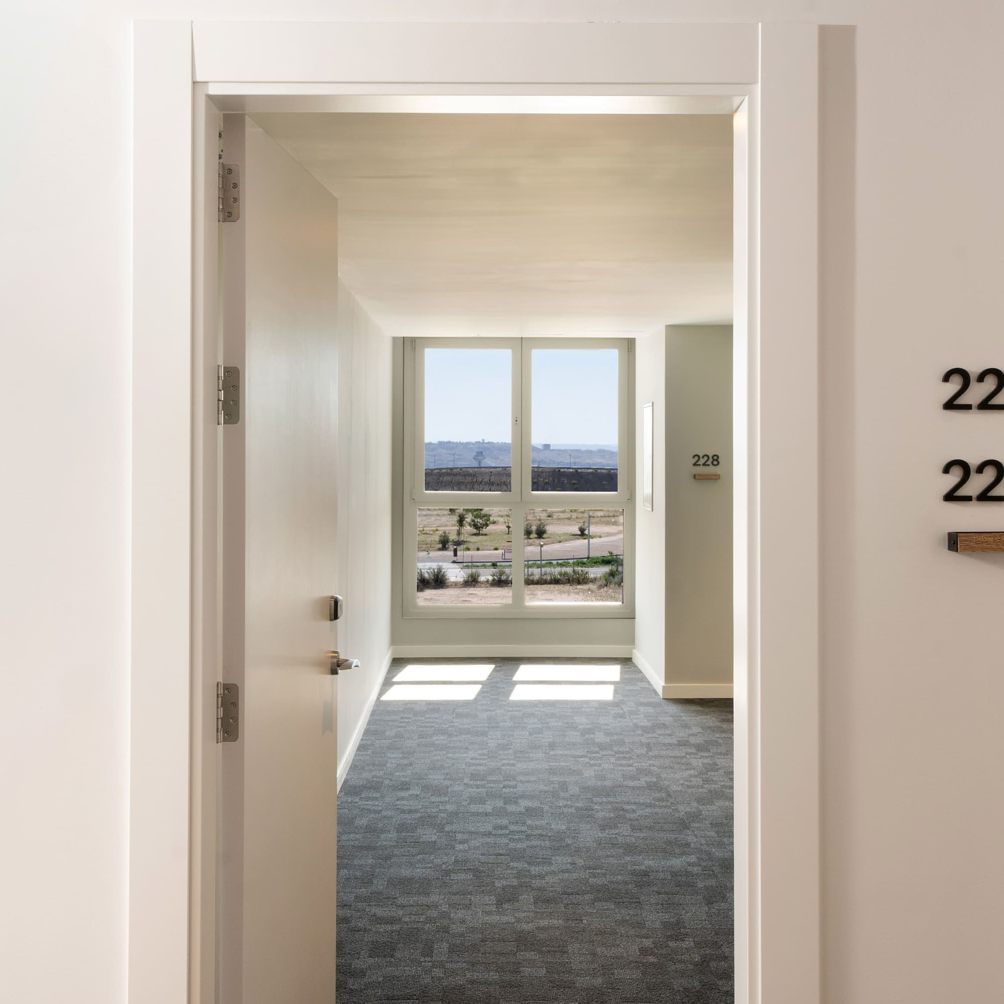 a hallway with a door and a window