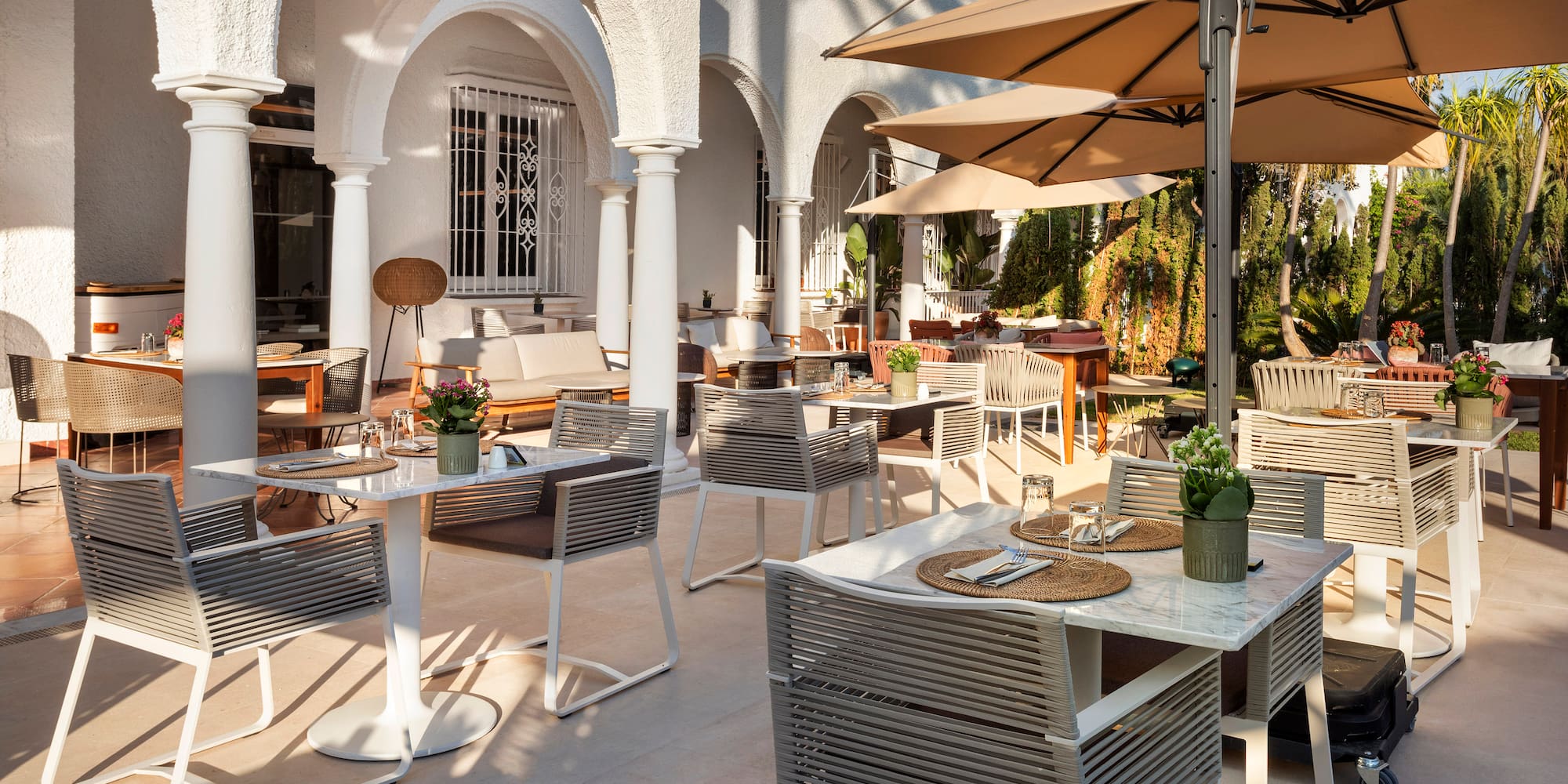 a patio with tables and chairs