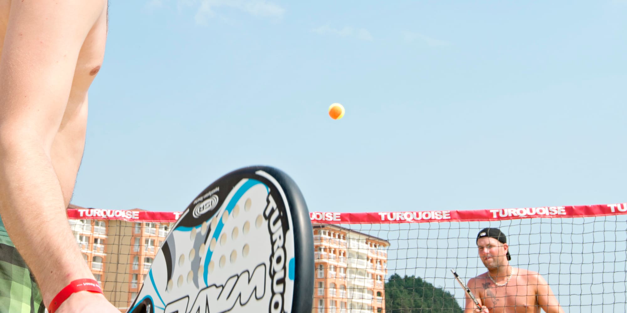a man playing beach tennis
