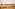 Hot air balloons above golden savanna, scattered trees, distant hills.