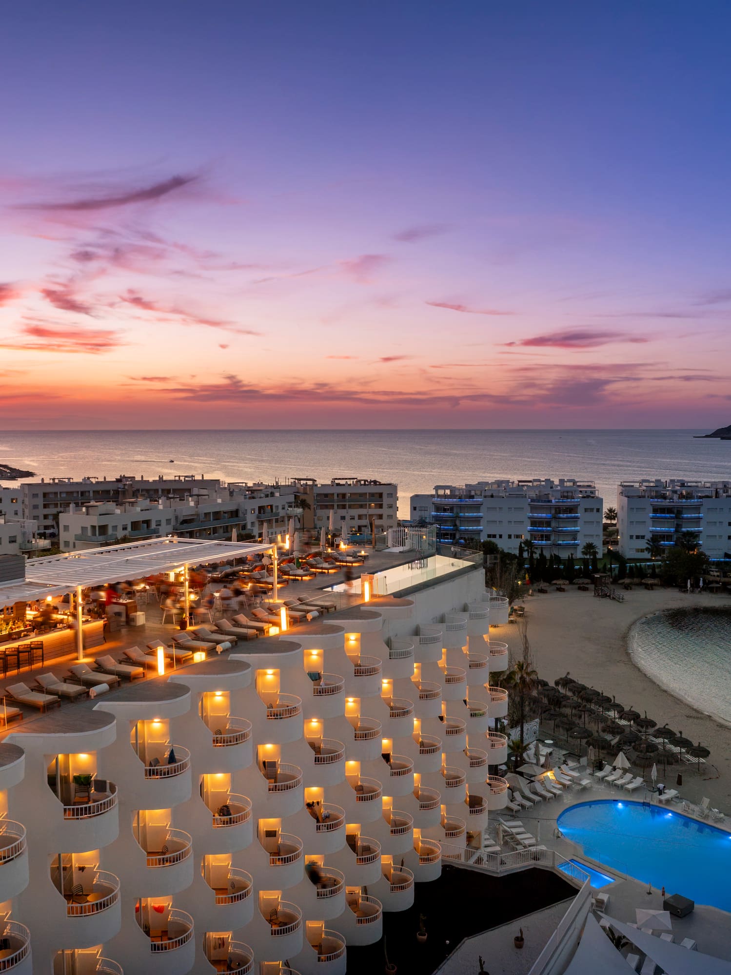 a hotel with a pool and a beach