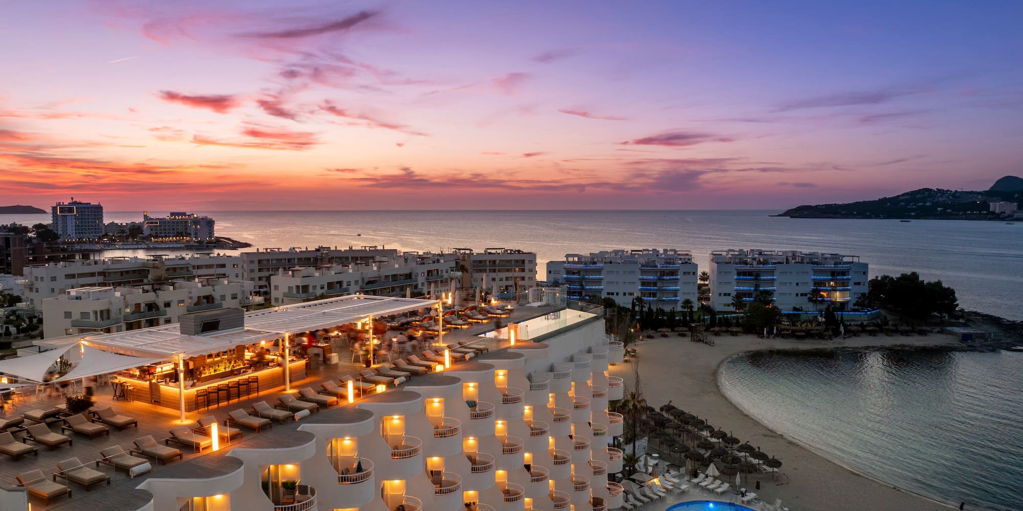 a hotel with a pool and a beach