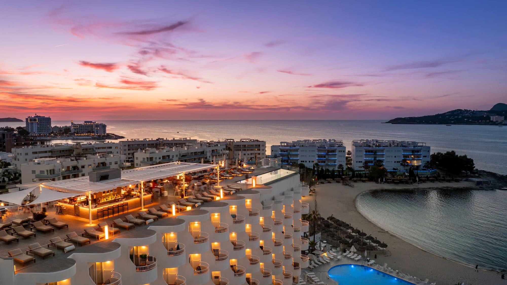 a hotel with a pool and a beach