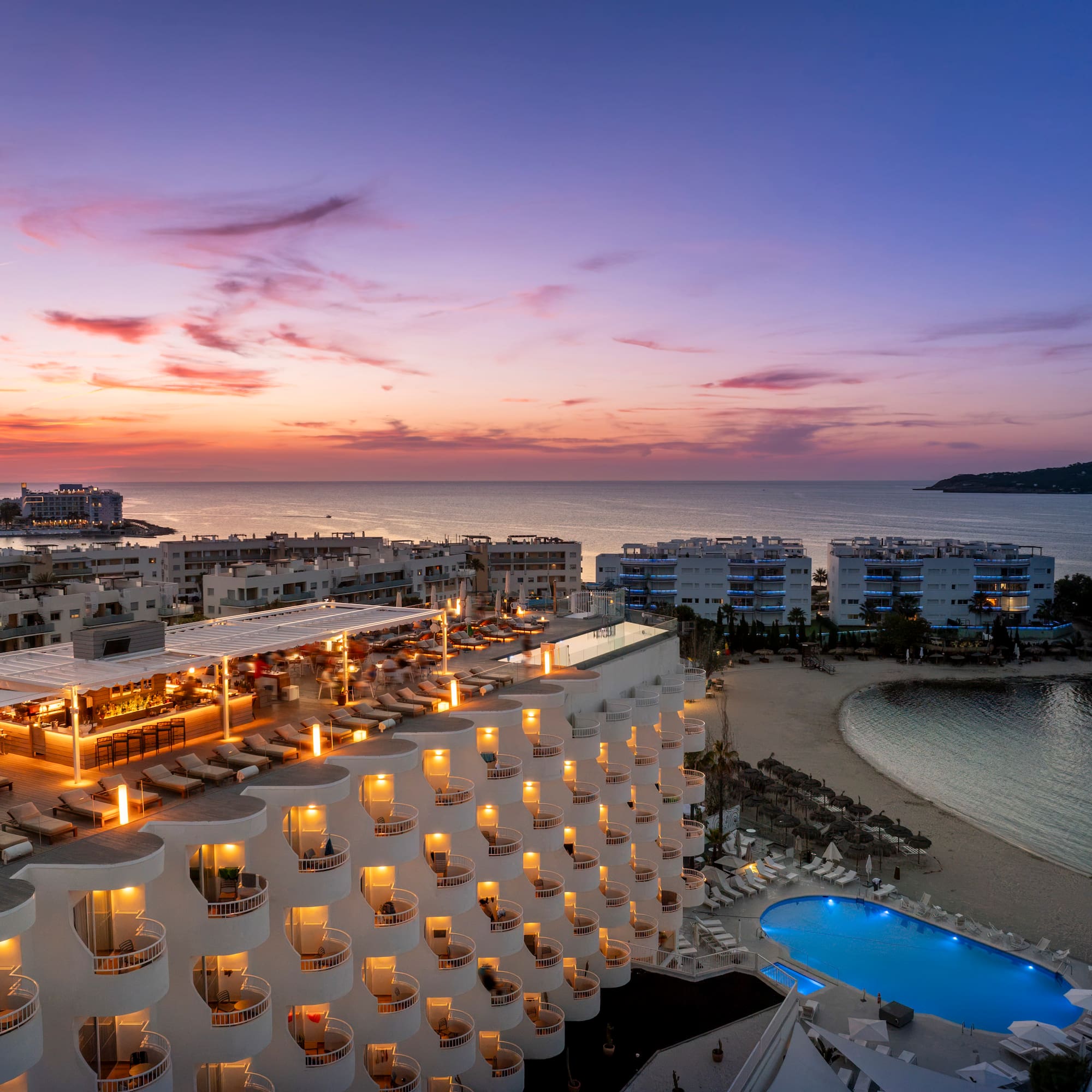 a hotel with a pool and a beach