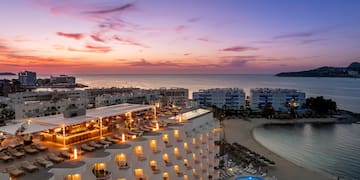 a hotel with a pool and a beach