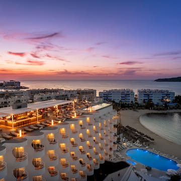 a hotel with a pool and a beach